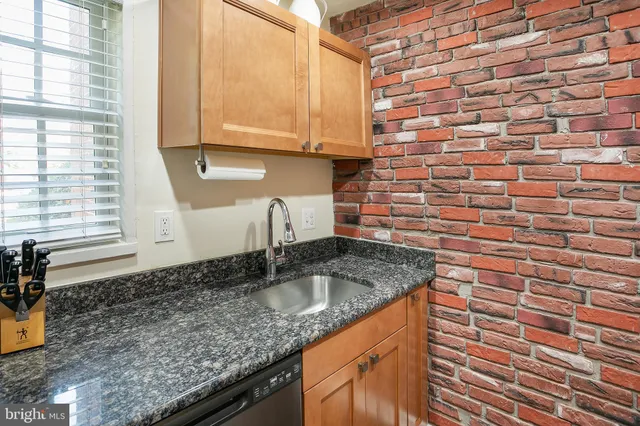 a kitchen with granite countertop a sink and a window