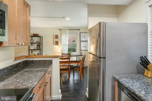 a kitchen with granite countertop a refrigerator and a sink