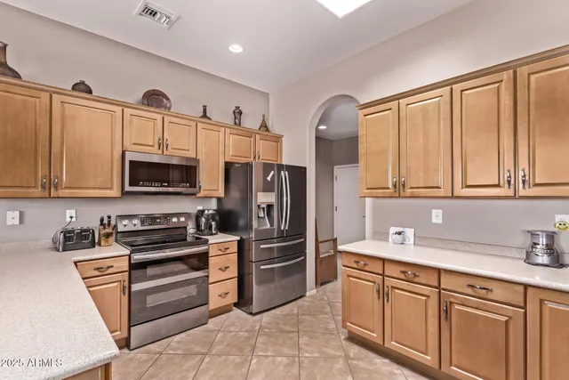 a kitchen with stainless steel appliances granite countertop a refrigerator sink and cabinets