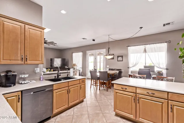 a kitchen with sink a stove and chairs