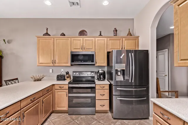 a kitchen with stainless steel appliances cabinets and a counter top space