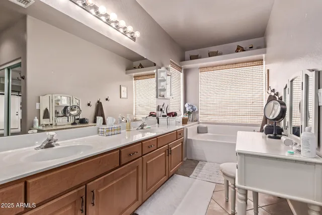 a bathroom with a double vanity sink mirror and