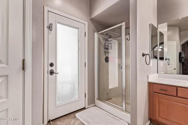 a bathroom with a shower and a sink