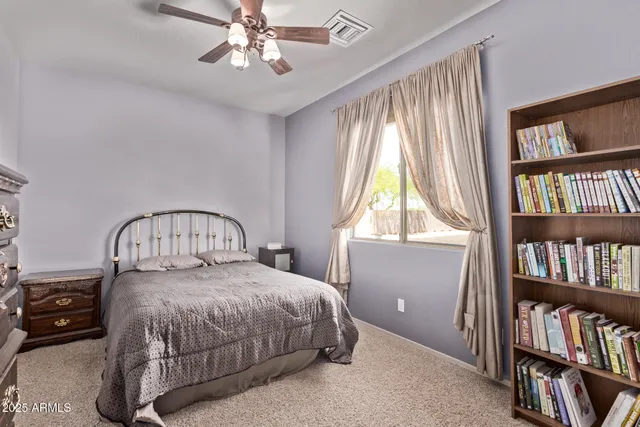 a bedroom with a bed next to a book shelf