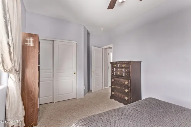 a bedroom with a dresser and a mirror