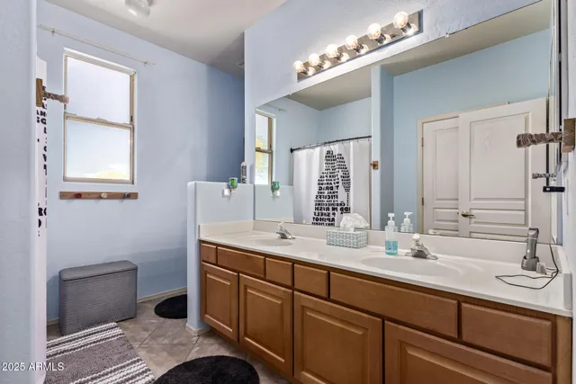 a bathroom with a sink double vanity and a mirror