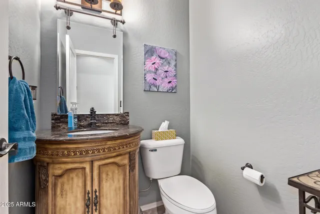 a bathroom with a toilet a sink and mirror