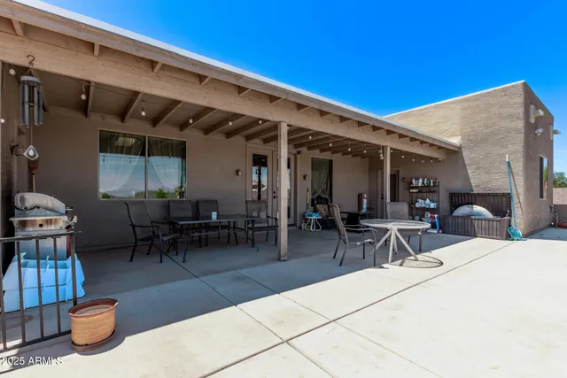 a view of a patio with table and chairs
