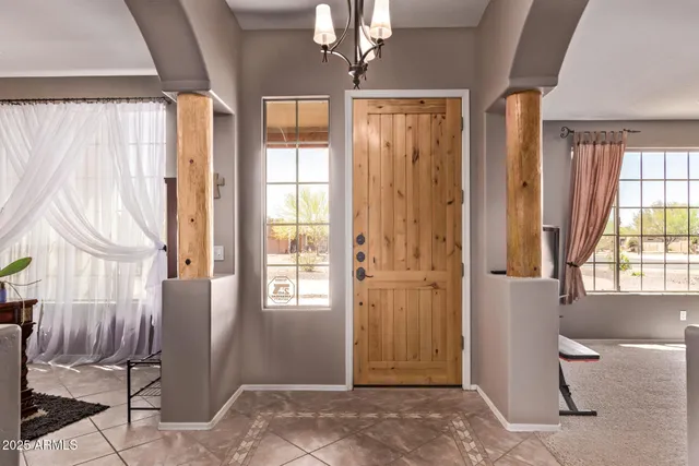 a view of a livingroom with a window and brick walls