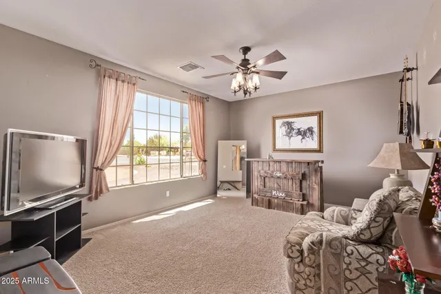 a bedroom with furniture and a flat screen tv