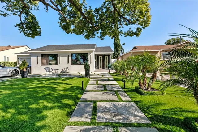 a front view of a house with a garden