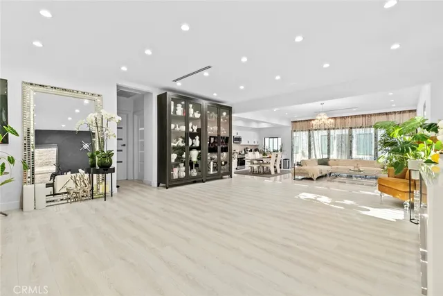 a kitchen with white cabinets stainless steel appliances and window
