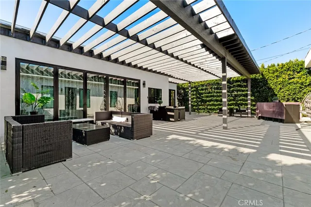 a kitchen with stainless steel appliances kitchen island granite countertop a refrigerator a stove a sink dishwasher and white cabinets with wooden floor