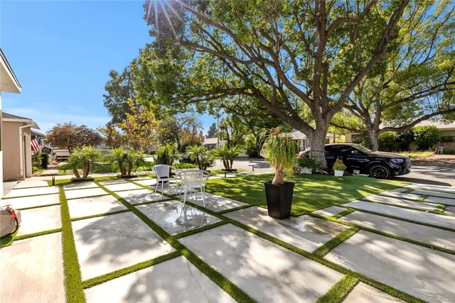 a view of a house with a yard patio and swimming pool