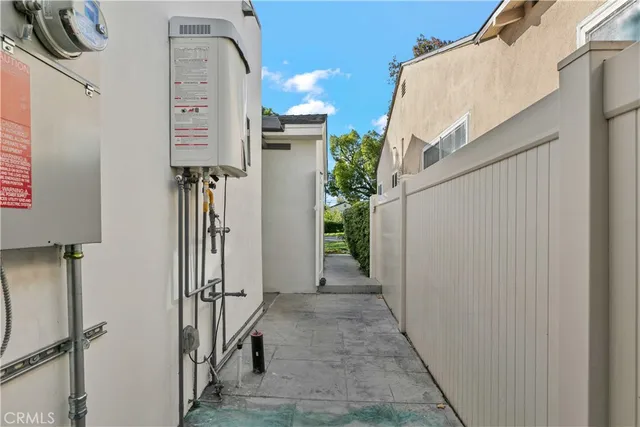 a view of a hallway with wooden floor and a bathroom