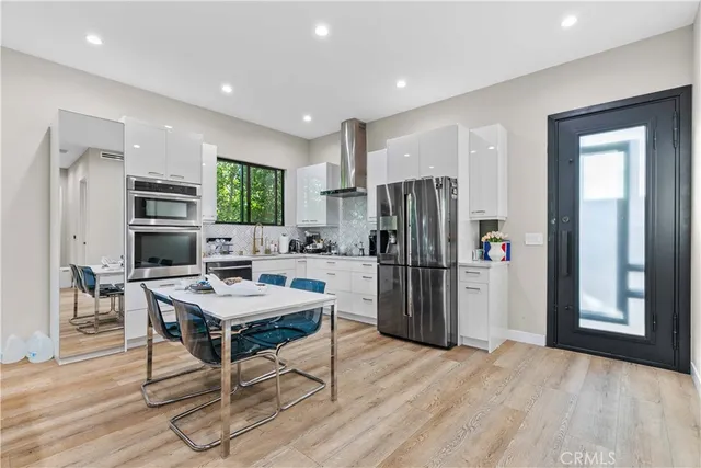 a bedroom with a bed and painting on the wall