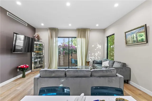 a view of a patio with table and chairs and potted plants