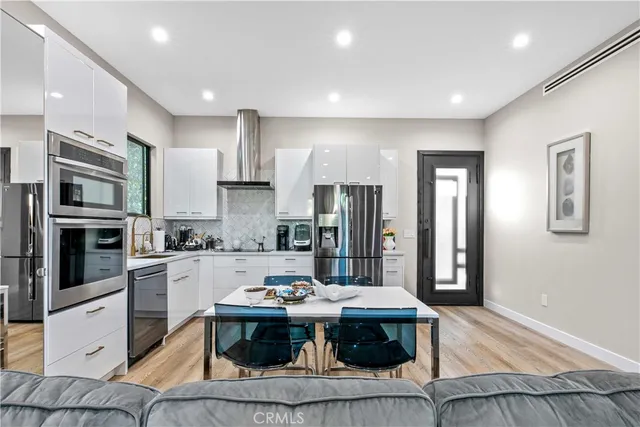 a view of a chairs and table in a backyard of a house