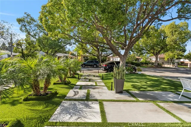 a view of a house with a small yard and plants