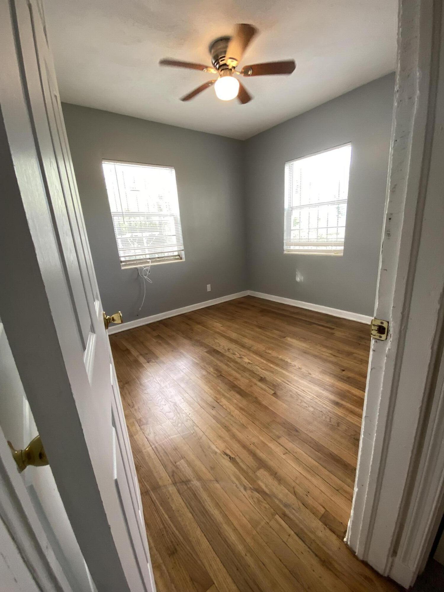119 West 25th Street, Unit B Riviera Beach, FL 33404 - Photo 5 of 7 wooden floor in an empty room with a window