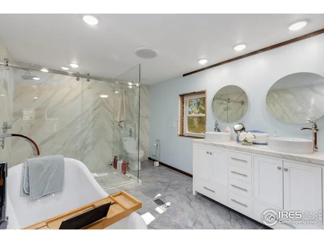 a bathroom with a toilet and a mirror