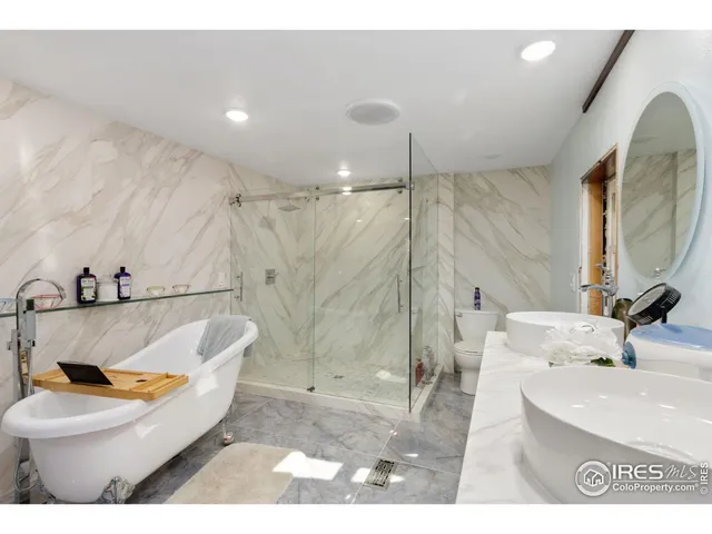 a white bath tub sitting in a bathroom next to a sink