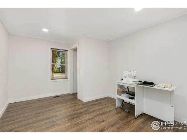 a view of a patio with table and chairs with an umbrella