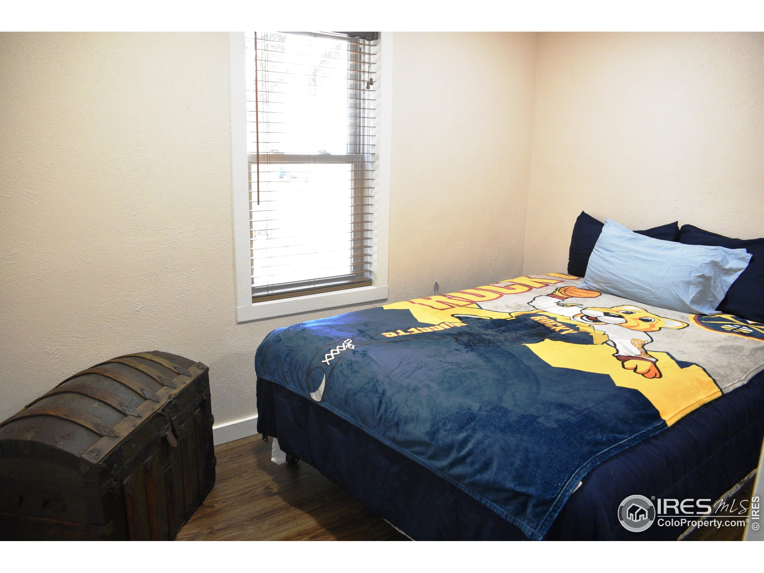2801 Farview Drive Fort Collins, CO 80524 - Photo 24 of 40 a bedroom with a bed with wooden floor