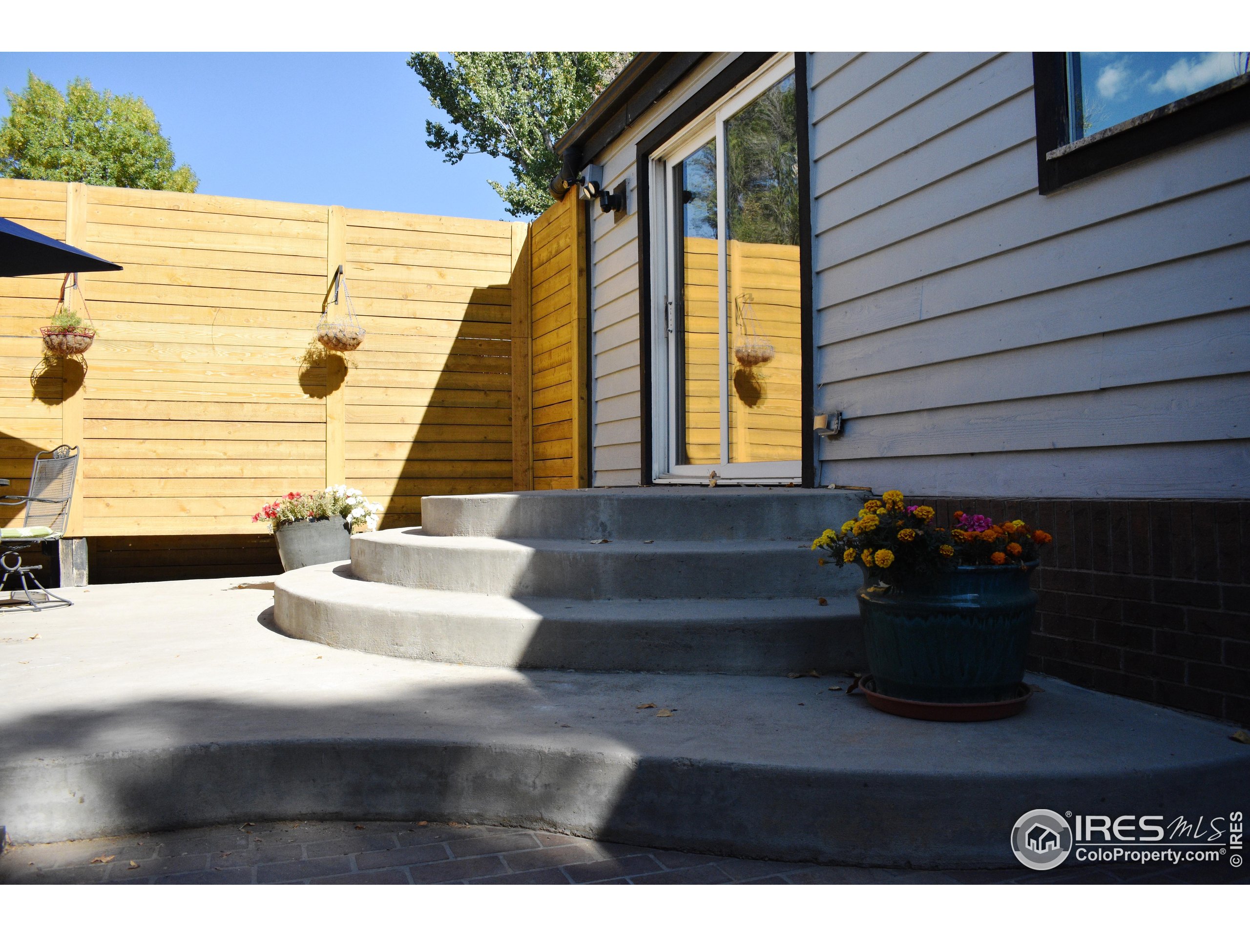 2801 Farview Drive Fort Collins, CO 80524 - Photo 5 of 40 a view of a house with chairs and potted plants