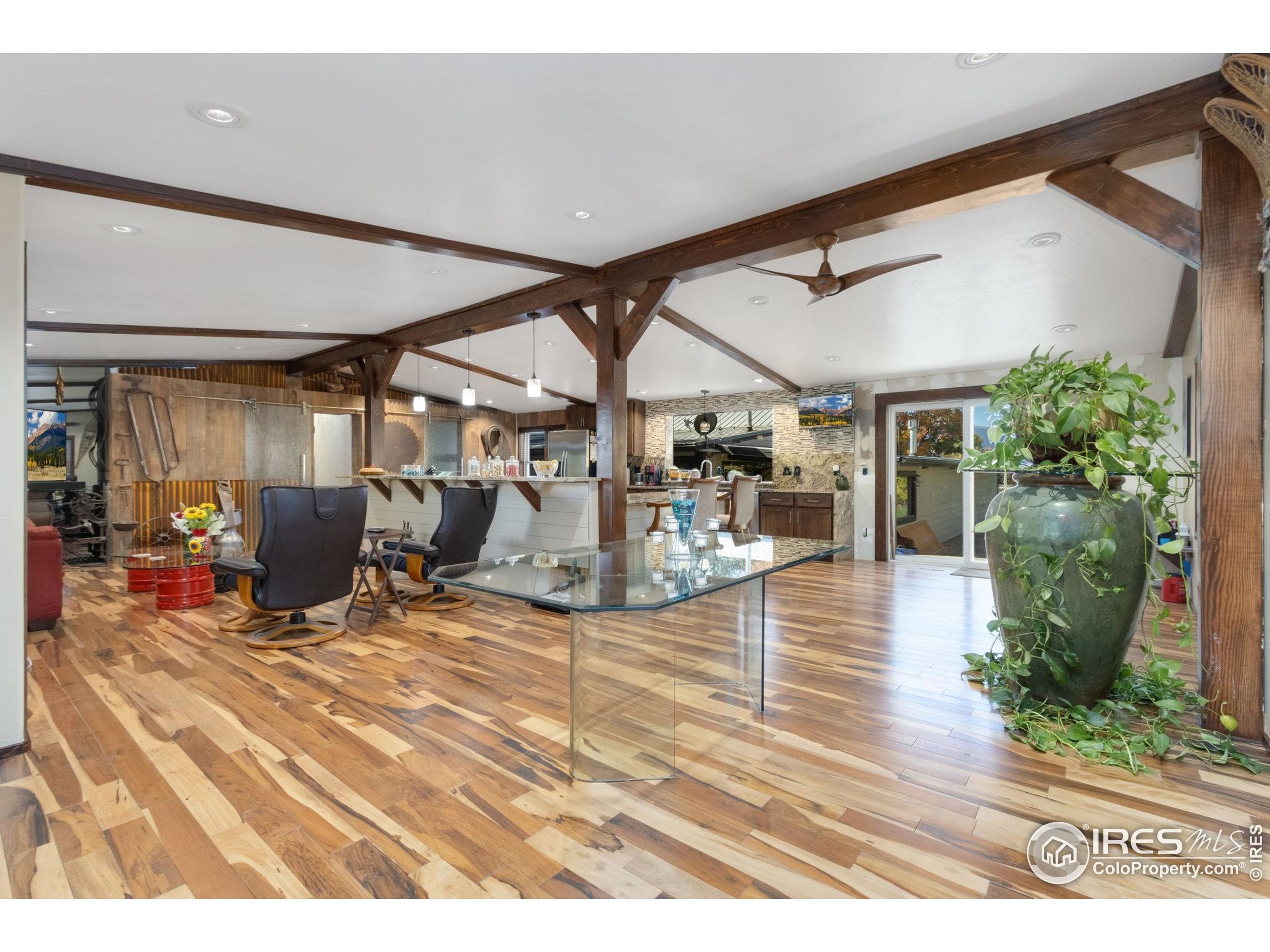 2801 Farview Drive Fort Collins, CO 80524 - Photo 8 of 40 a view of a patio with table and chairs potted plants and floor to ceiling window