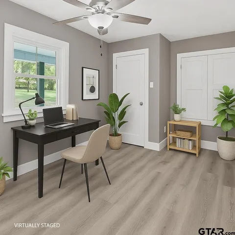 a living room with furniture and a potted plant