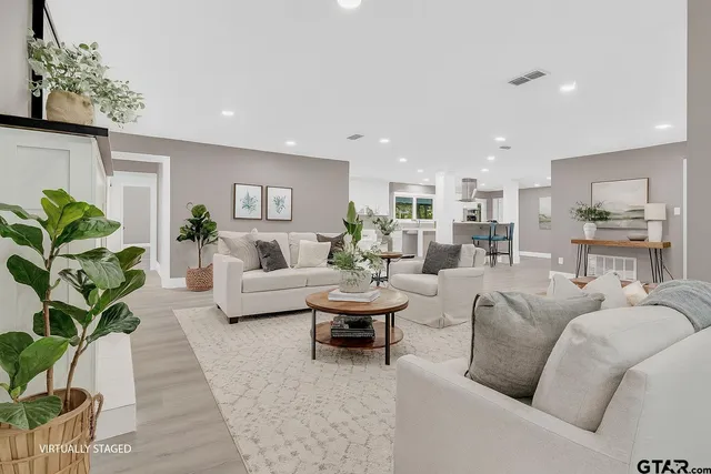 a living room with furniture potted plant and a table