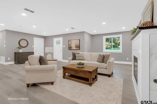 a living room with furniture and a fireplace