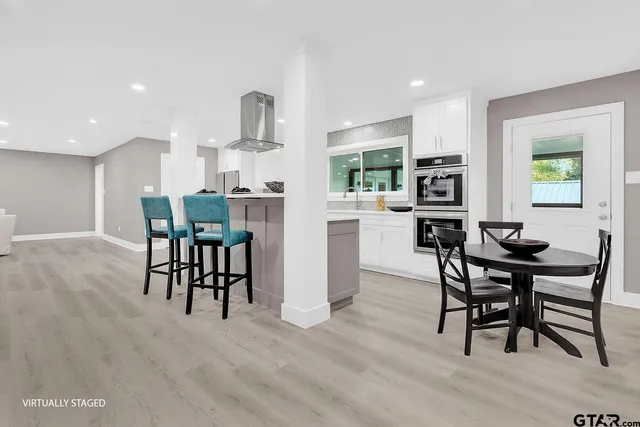 a view of a dining room with furniture and a wooden floor