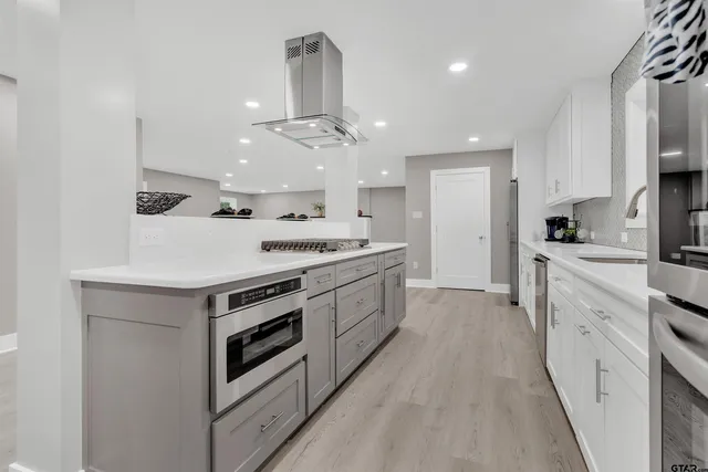 a kitchen with stainless steel appliances a sink stove and cabinets