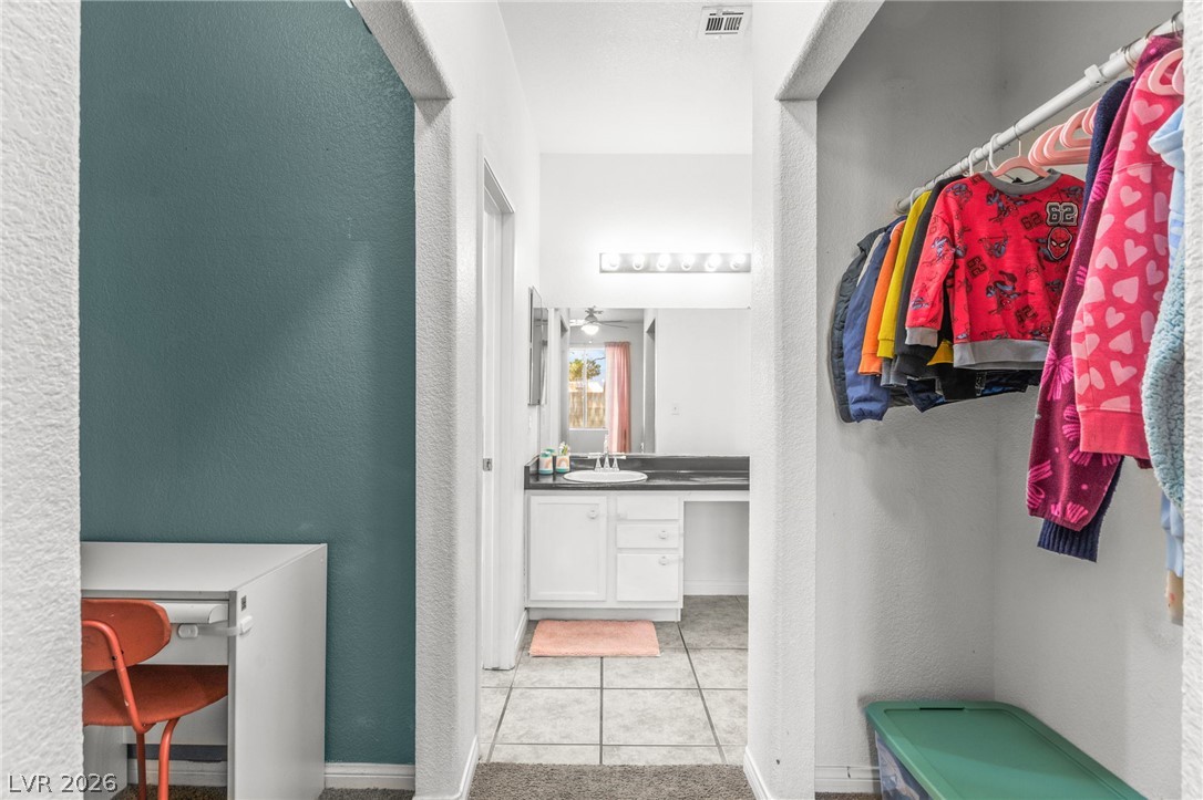 7353 Ridge Star Court Las Vegas, NV 89131 - Photo 24 of 36 Functional vanity space and organized storage solutions define this practical interior corridor.