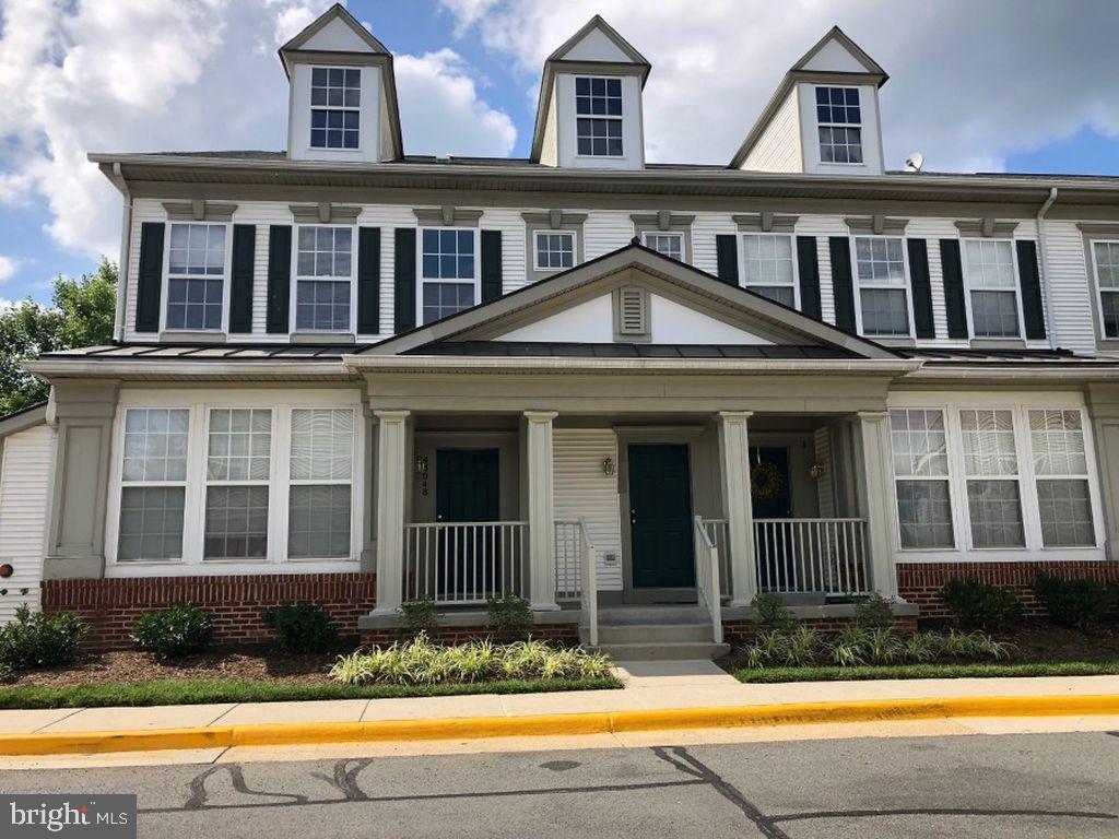 43048 Zander Terrace Ashburn, VA 20147 - Photo 1 of 18 a front view of a house with swimming pool and porch