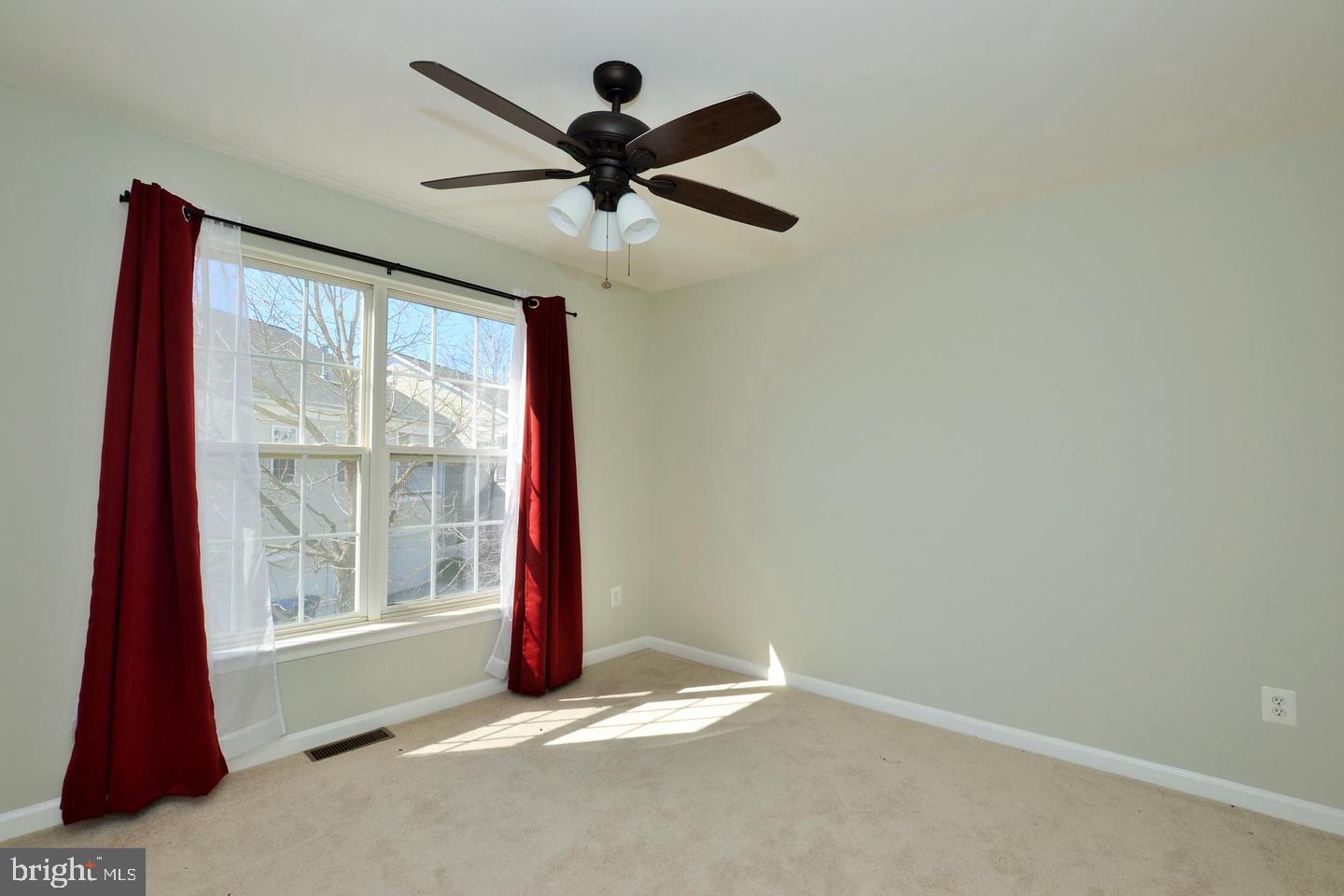 43048 Zander Terrace Ashburn, VA 20147 - Photo 14 of 18 a view of a livingroom with a ceiling fan and window