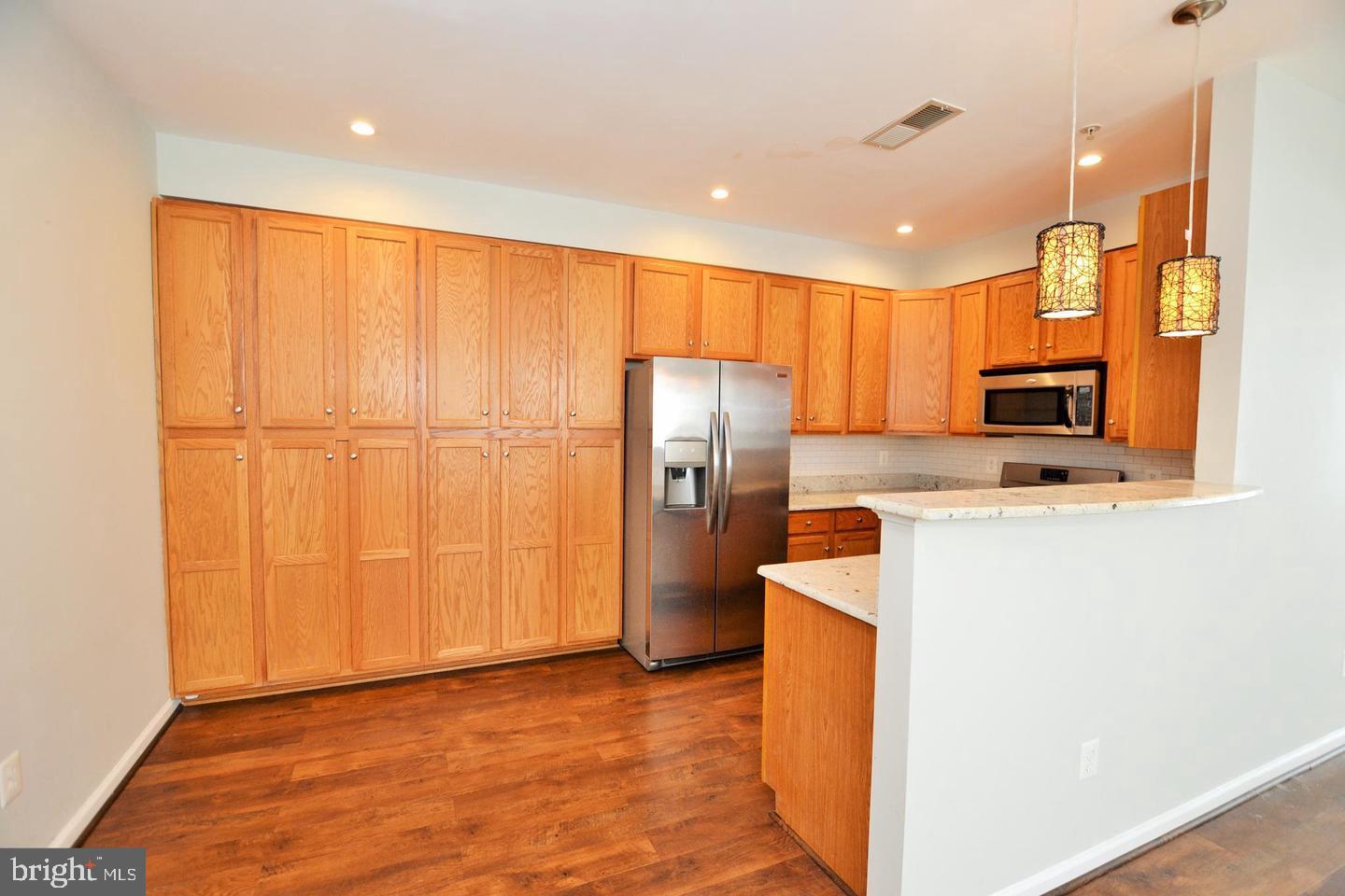 43048 Zander Terrace Ashburn, VA 20147 - Photo 3 of 18 a kitchen with stainless steel appliances a refrigerator and a stove top oven