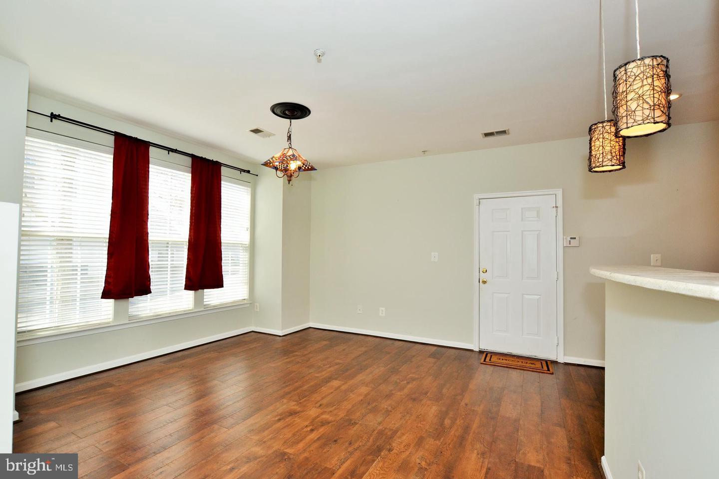 43048 Zander Terrace Ashburn, VA 20147 - Photo 4 of 18 a view of an entryway with wooden floor