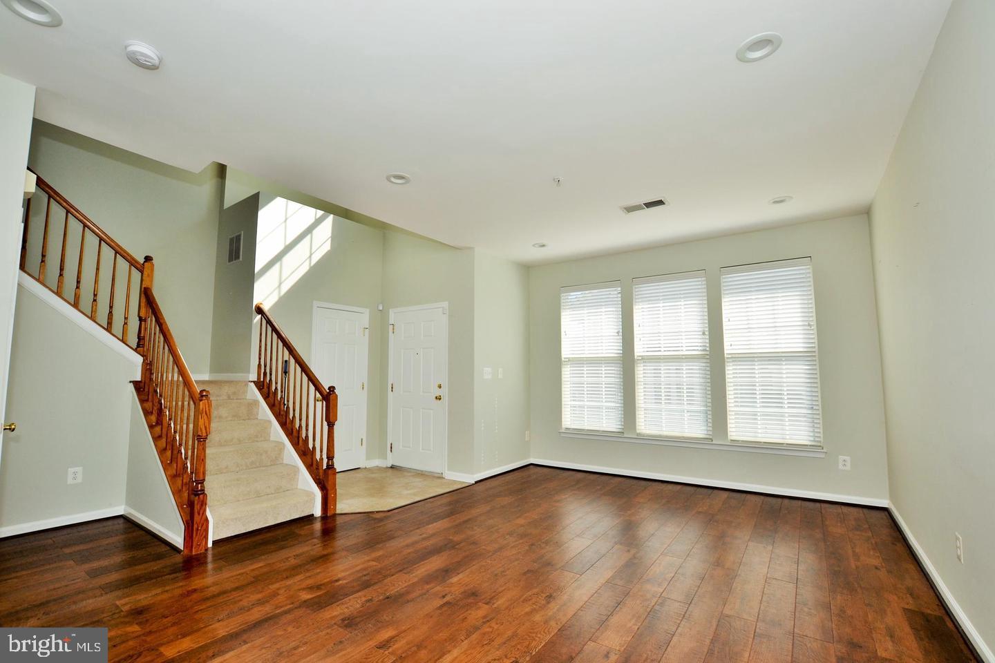43048 Zander Terrace Ashburn, VA 20147 - Photo 5 of 18 a view of an empty room with wooden floor and a window