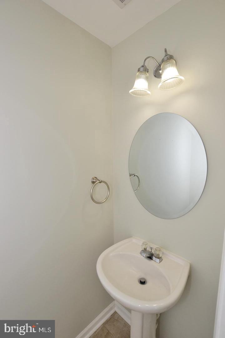 43048 Zander Terrace Ashburn, VA 20147 - Photo 7 of 18 a bathroom with a sink and a mirror