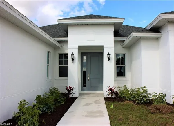 a front view of a house with flowers