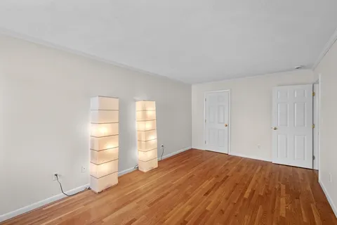 a view of walk in closet with empty racks