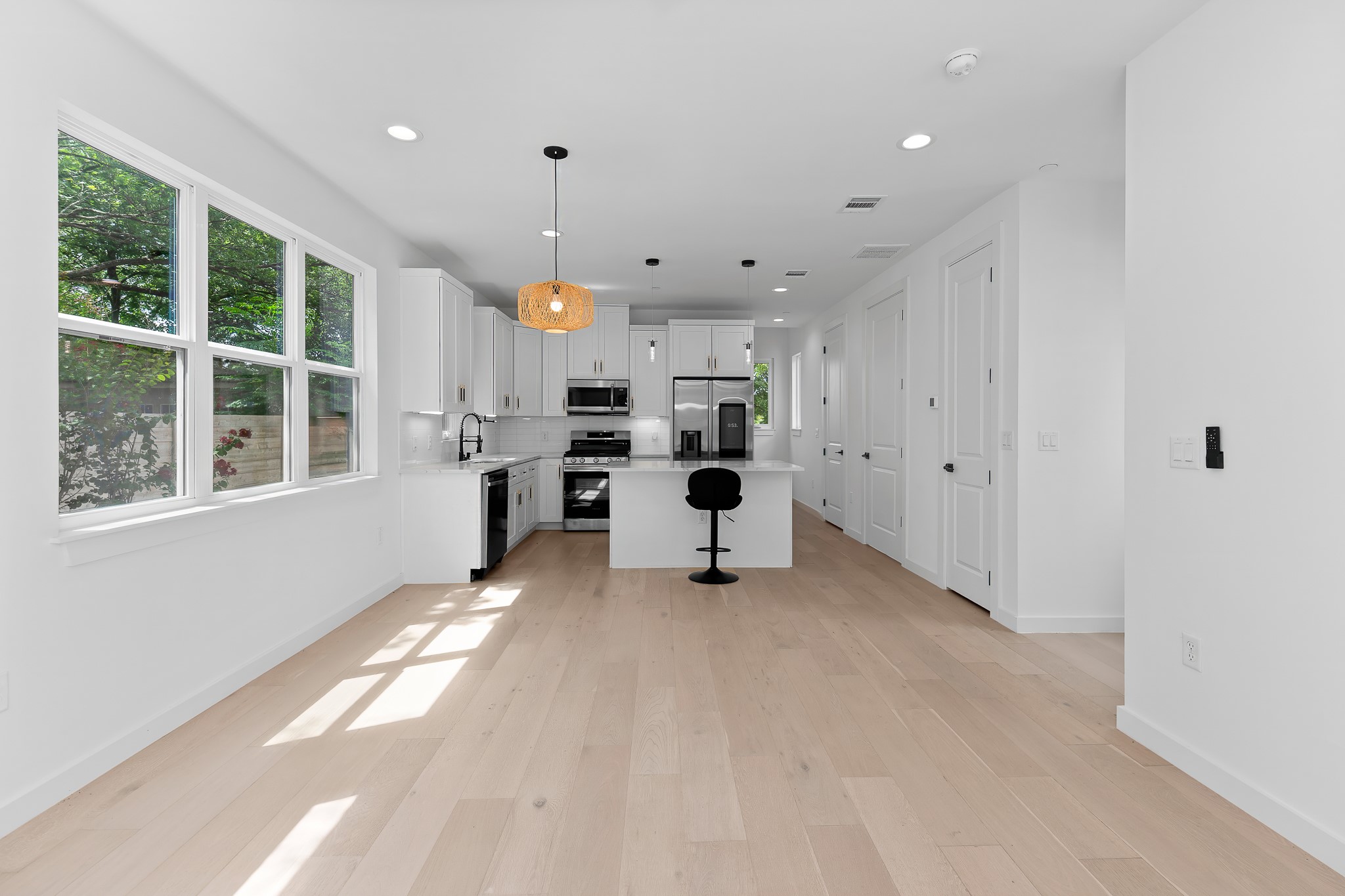5305 Ledesma Road, Unit 4 Austin, TX 78721 - Photo 11 of 40 A luminous open-concept kitchen and living area features pristine hardwood floors and generous natural light.