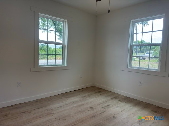 602 South 26th Street Temple, TX 76501 - Photo 7 of 11 an empty room with wooden floor and windows