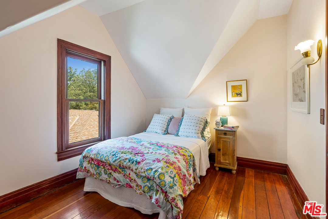 545 Westgate Street Pasadena, CA 91103 - Photo 28 of 41 a bedroom with a bed and wooden floor