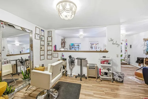 a living room with furniture a flat screen tv and a table