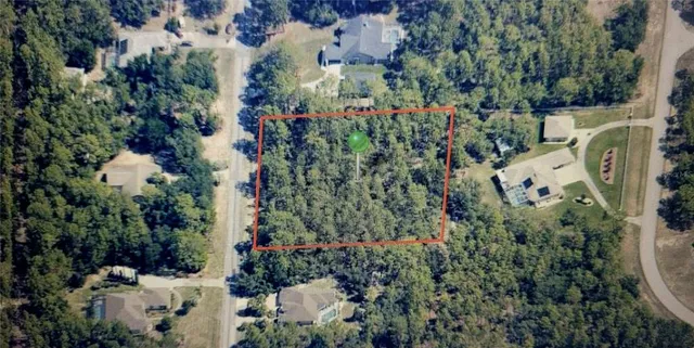 an aerial view of a house with a yard and garden