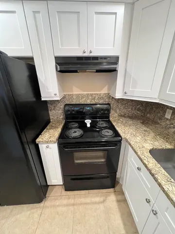 a stove top oven sitting inside of a kitchen